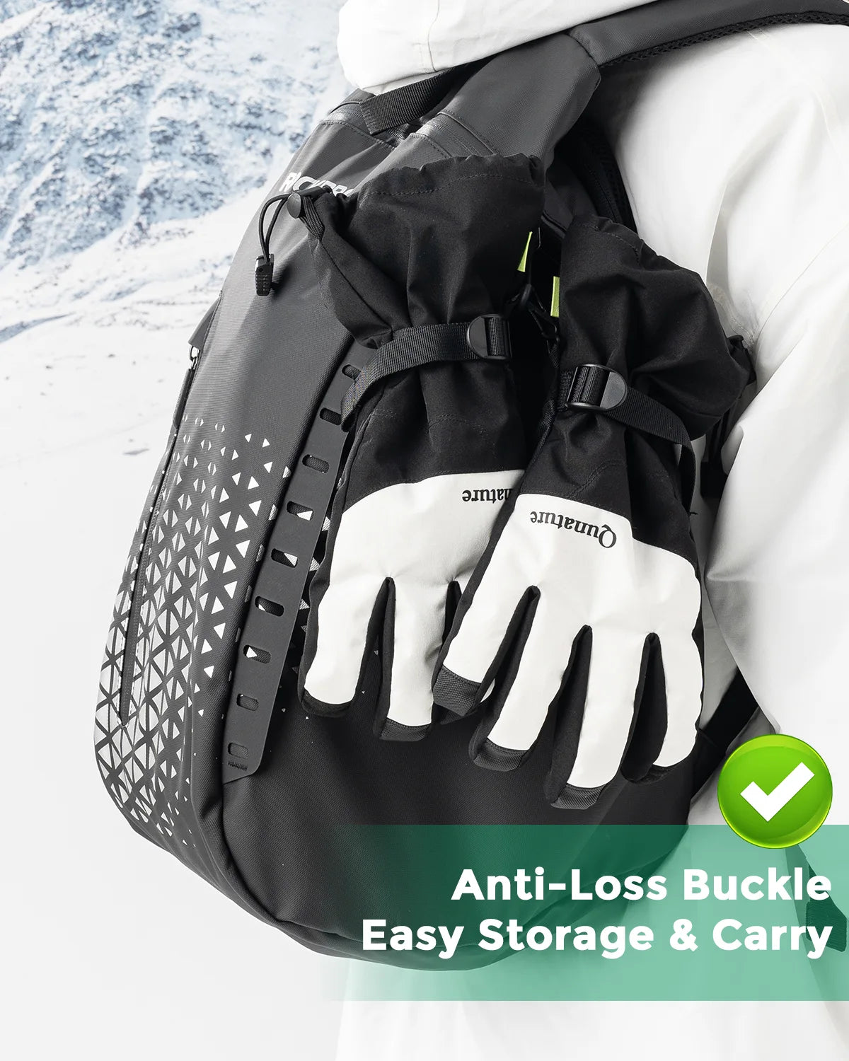 Black backpack with anti-loss buckle feature, shown with gloves on a snowy background