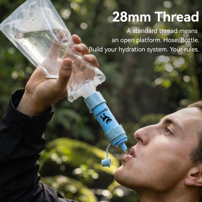 Person using a water bottle with a hose attachment outdoors