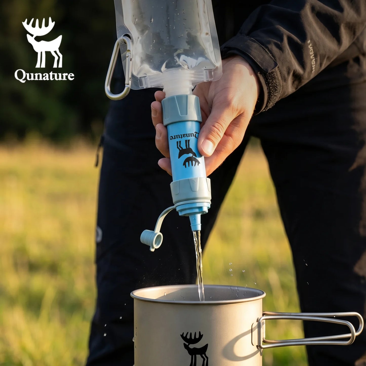 Person using a Qunature water filter to pour water into a mug outdoors.