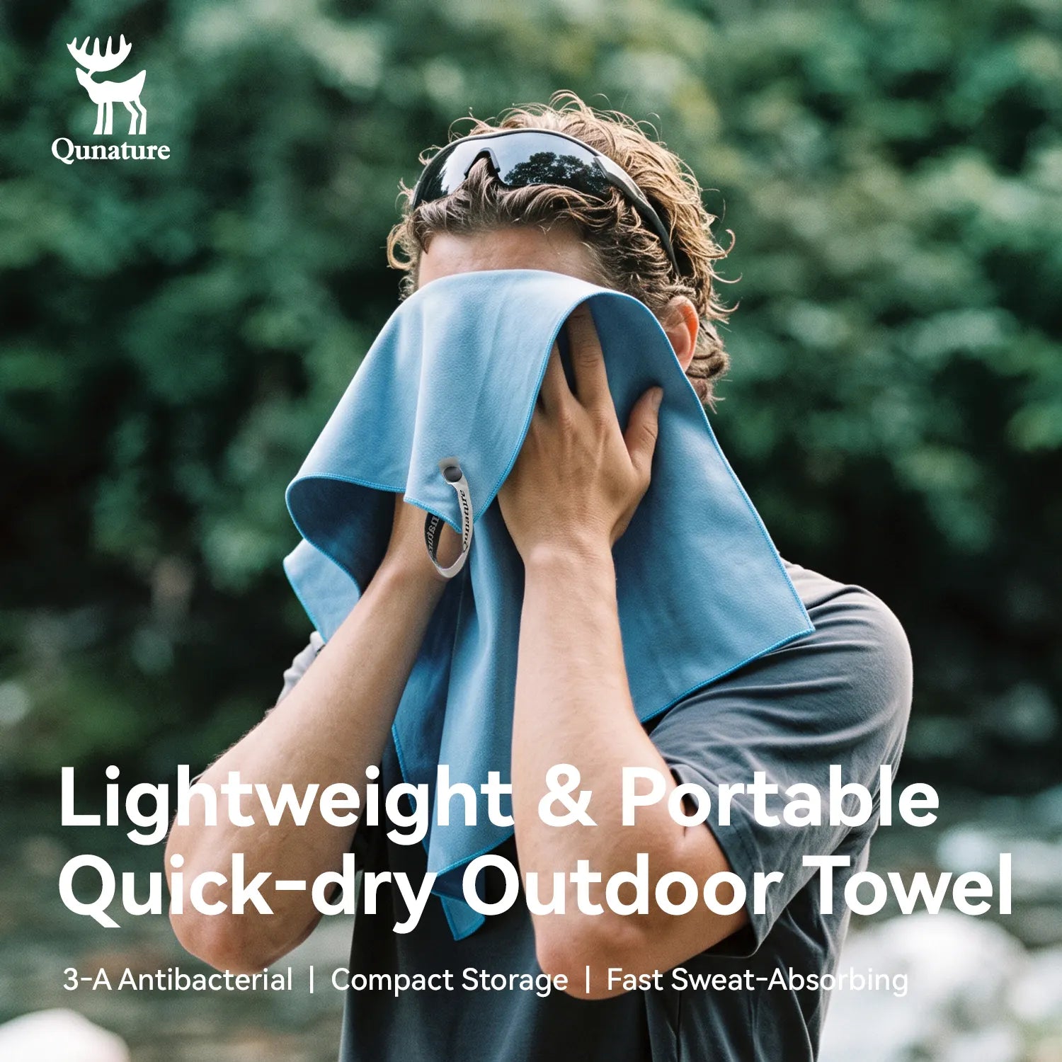 A man outdoors drying his face with a light blue quick-dry towel. The image features the Qunature brand logo in the top-left corner and text overlays at the bottom highlighting the towel's lightweight, portable, and quick-dry qualities.