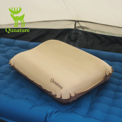 Beige camping pillow with 'Qunature' branding on a blue sleeping pad, with Qunature logo in the corner.