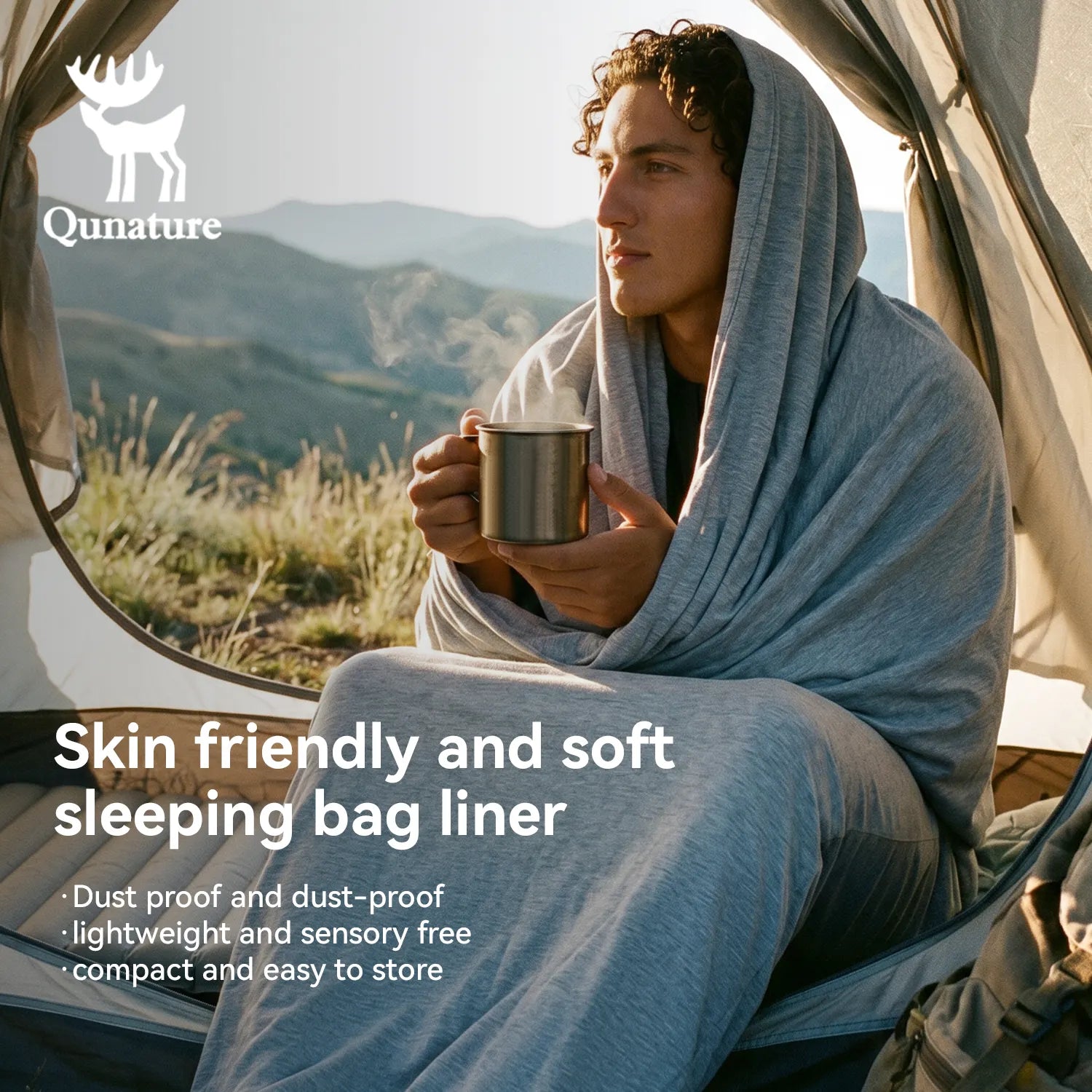 Person wrapped in a sleeping bag liner holding a mug, with mountains in the background, featuring Qunature branding.