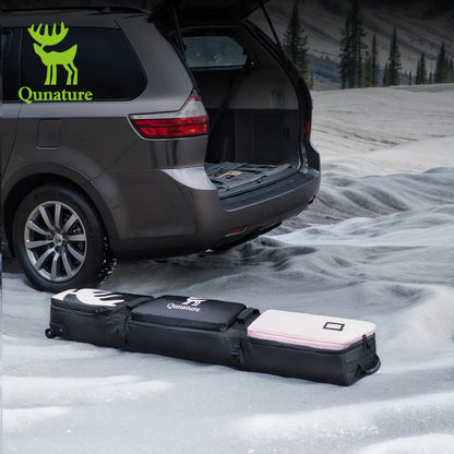 This pink snowboard bag with PU wheels is lying in the snow next to a car with its trunk open.