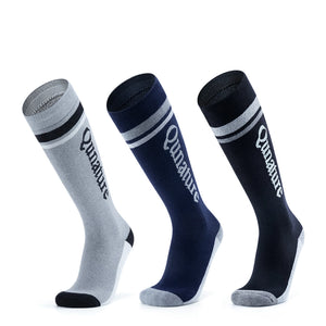 Three different colored ski socks with monogram patterns
