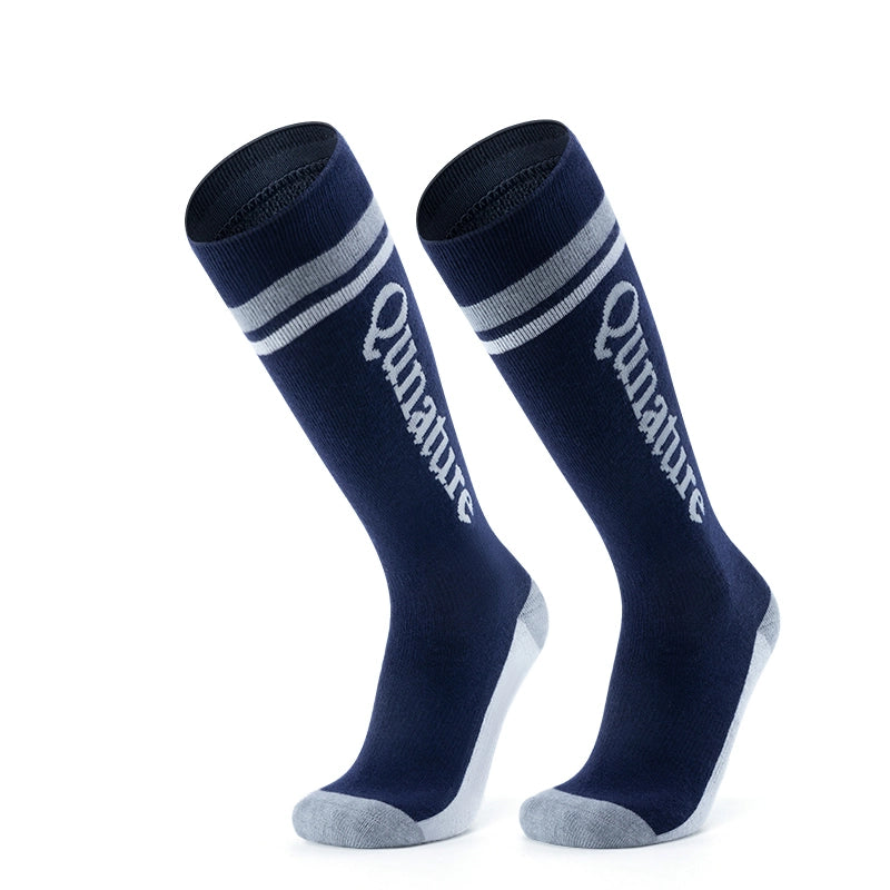 A pair of dark blue long ski socks with monogram pattern
