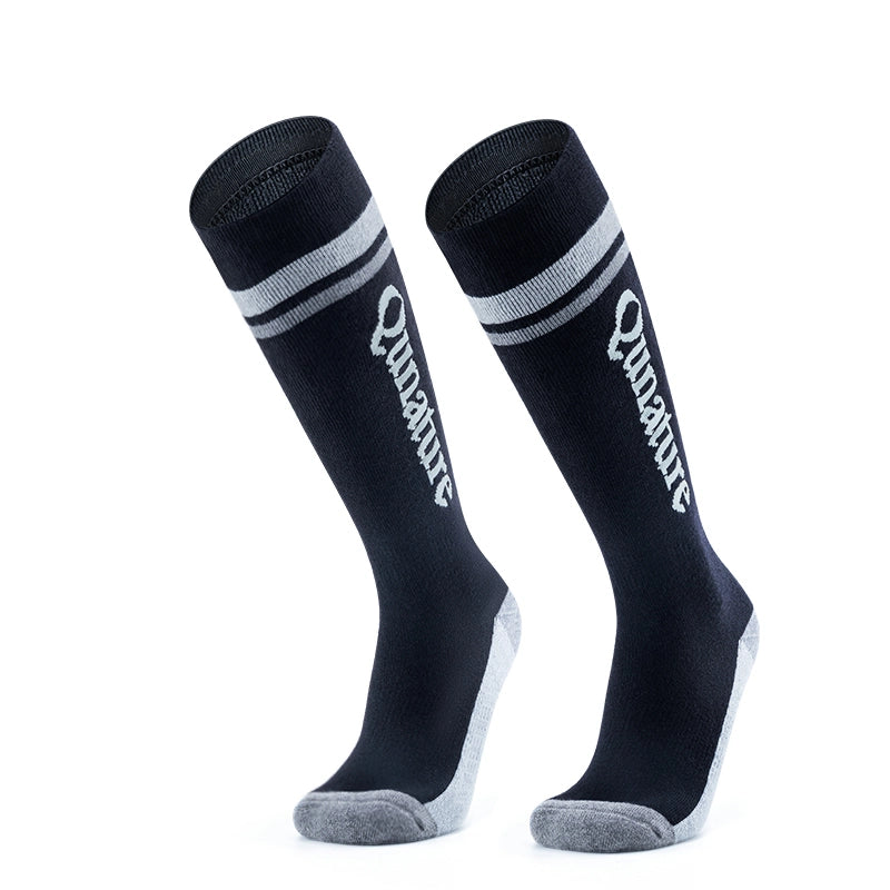 A pair of black long ski socks with monogram pattern