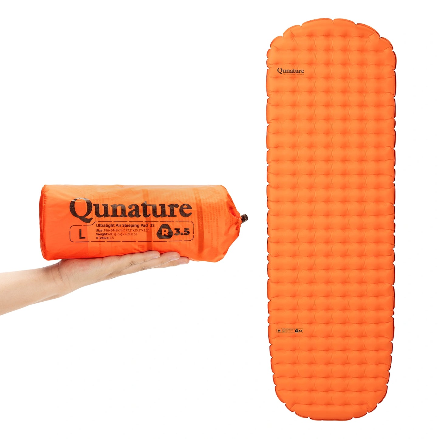 Orange inflatable sleeping pad with packaging held by a hand on a white background