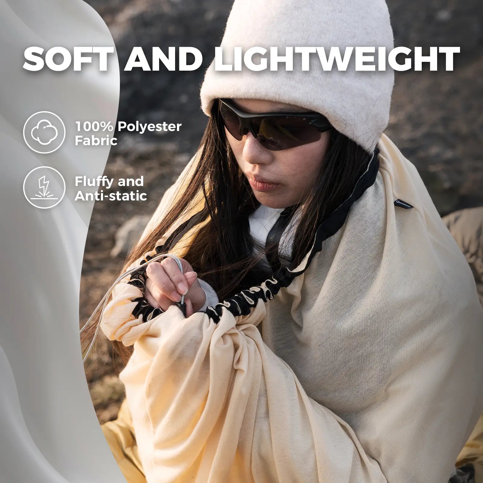 Person holding a beige fabric with text about softness and lightweight properties.