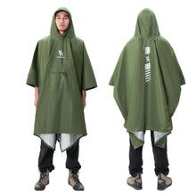 Green rain poncho worn by a person on a white background