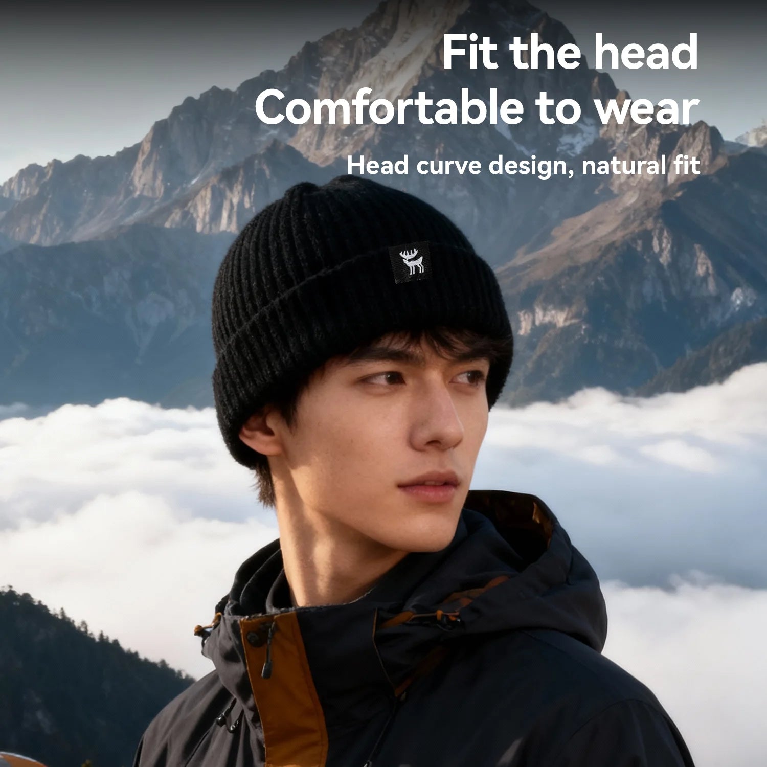 Person wearing a black knit beanie with a mountainous background