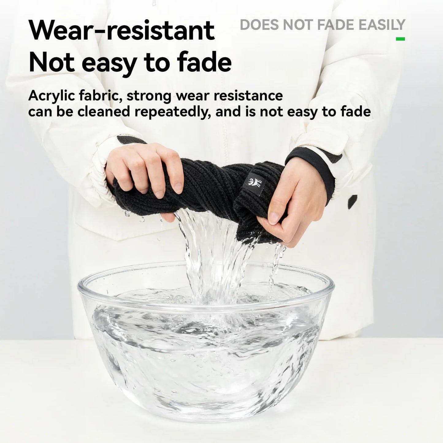 Person holding a black fabric over a clear bowl with text about wear-resistance and fade resistance.