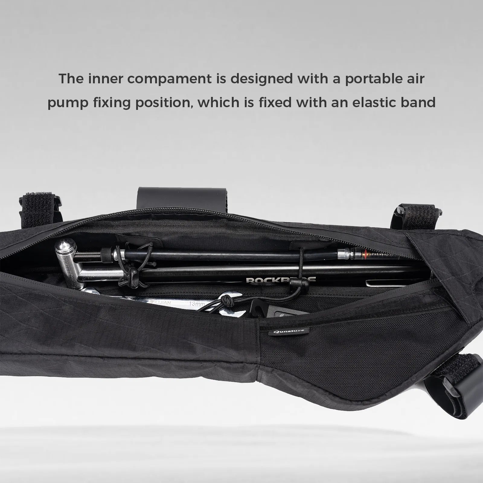 Black bag with a portable air pump inside, on a gray background