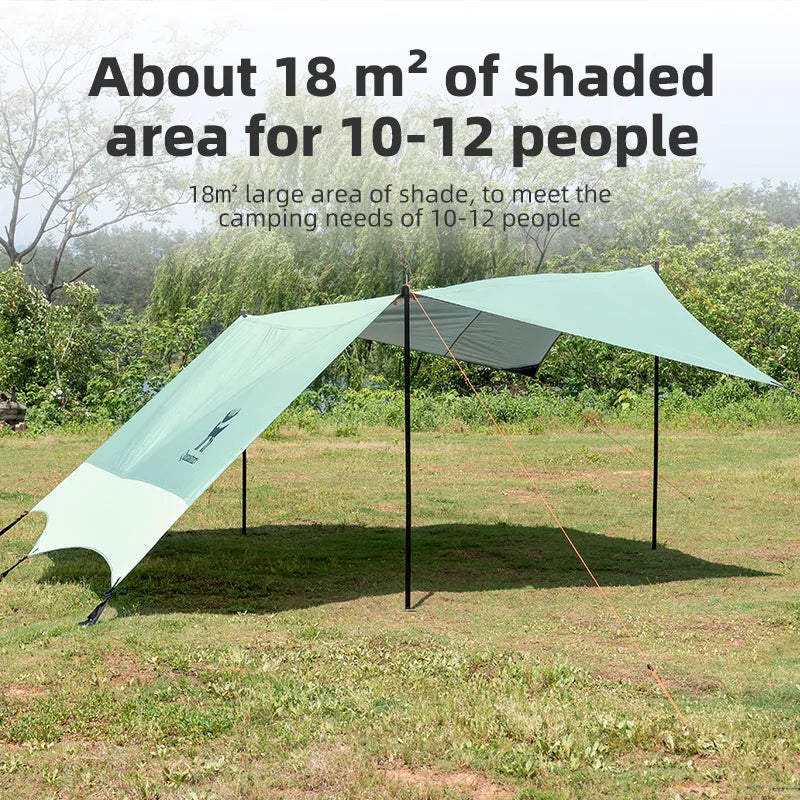 Green camping tarp providing shade for 10-12 people in an outdoor setting