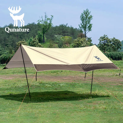 Camping tarp with Qunature logo on a grassy field with trees in the background