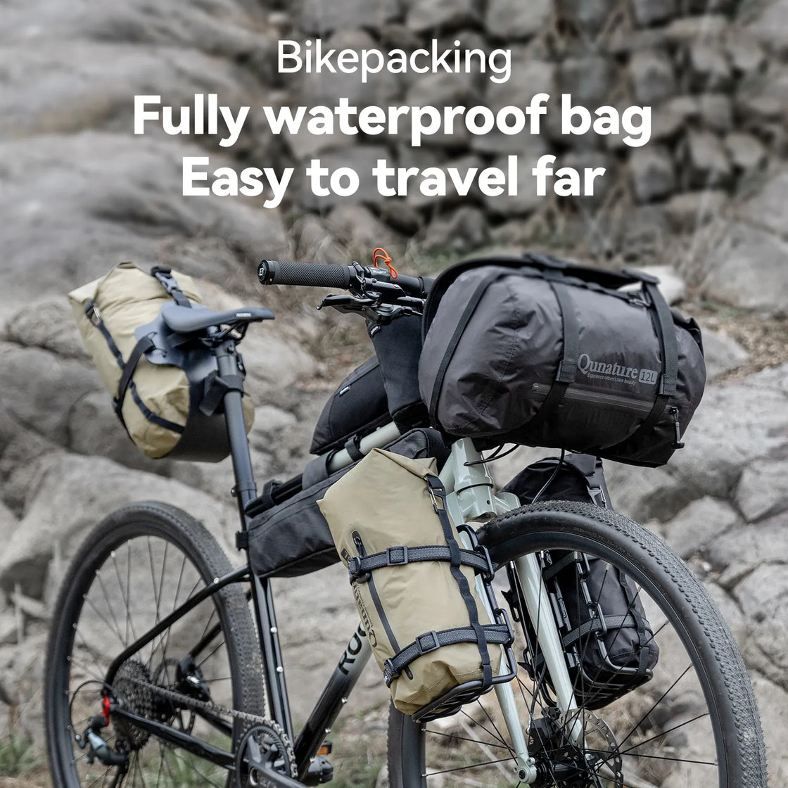 A black waterproof compression bag is fixed to the bicycle outdoors