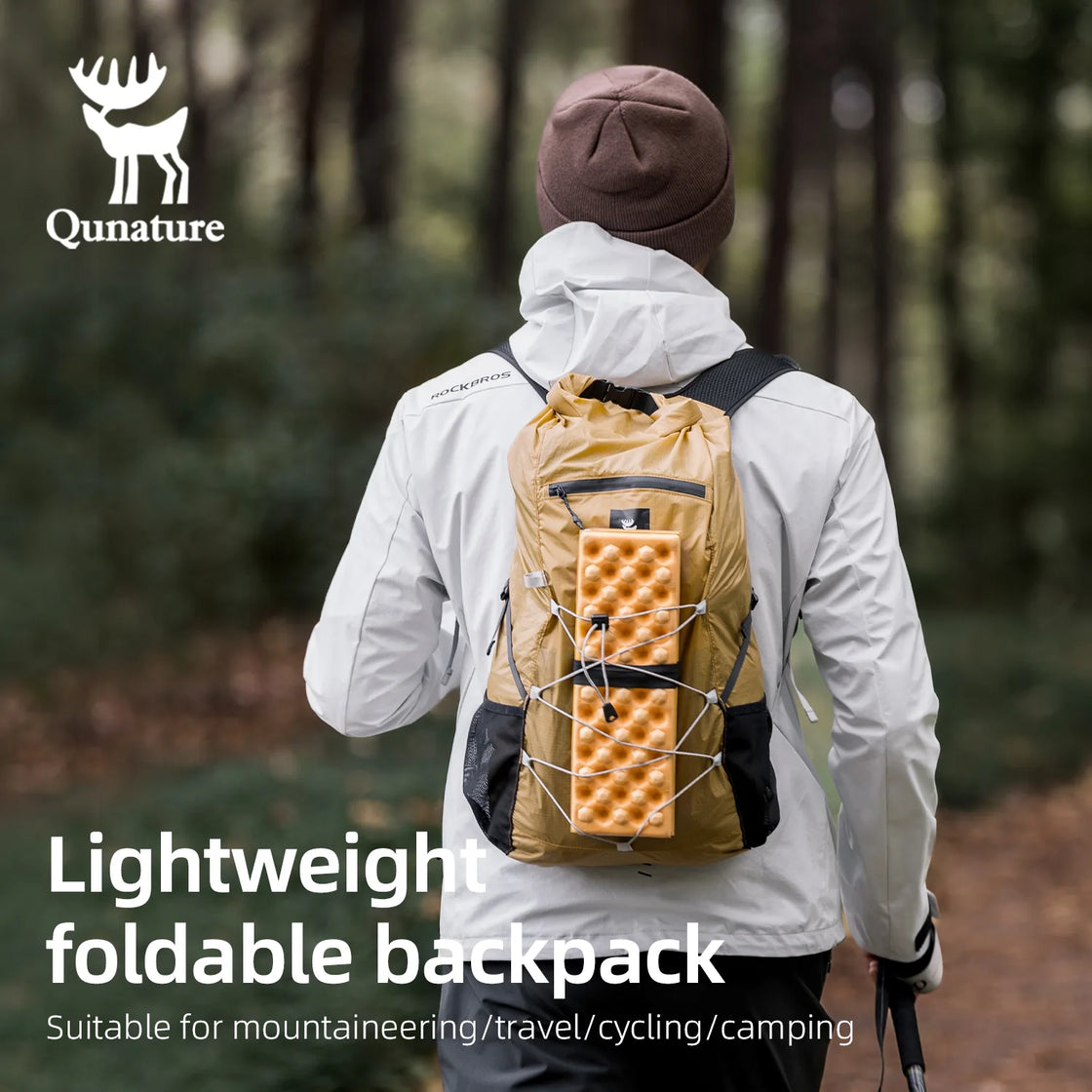 Person wearing a khaki backpack in a forest setting