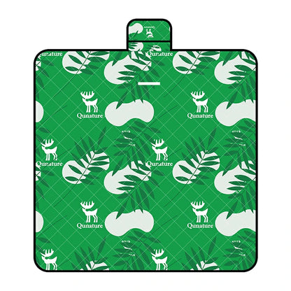 A Qunature branded outdoor picnic mat with a patterned design featuring elements like mountains, trees, and camping gear, in green, beige, and other colors.
