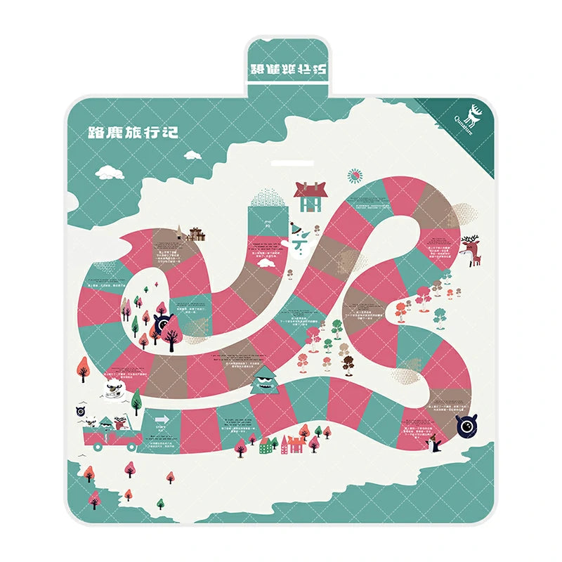 A Qunature branded outdoor picnic mat with a patterned design featuring elements like mountains, trees, and camping gear, in green, beige, and other colors.