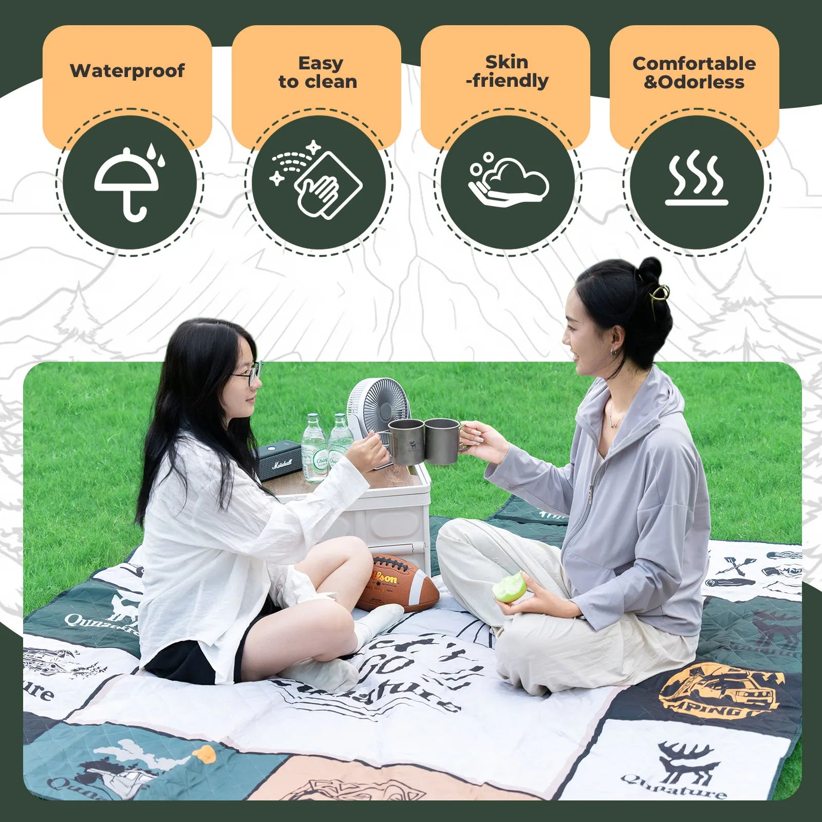 Two people sitting on a quilt with product features listed above them.