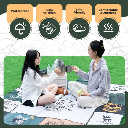 Two people sitting on a quilt with product features listed above them.