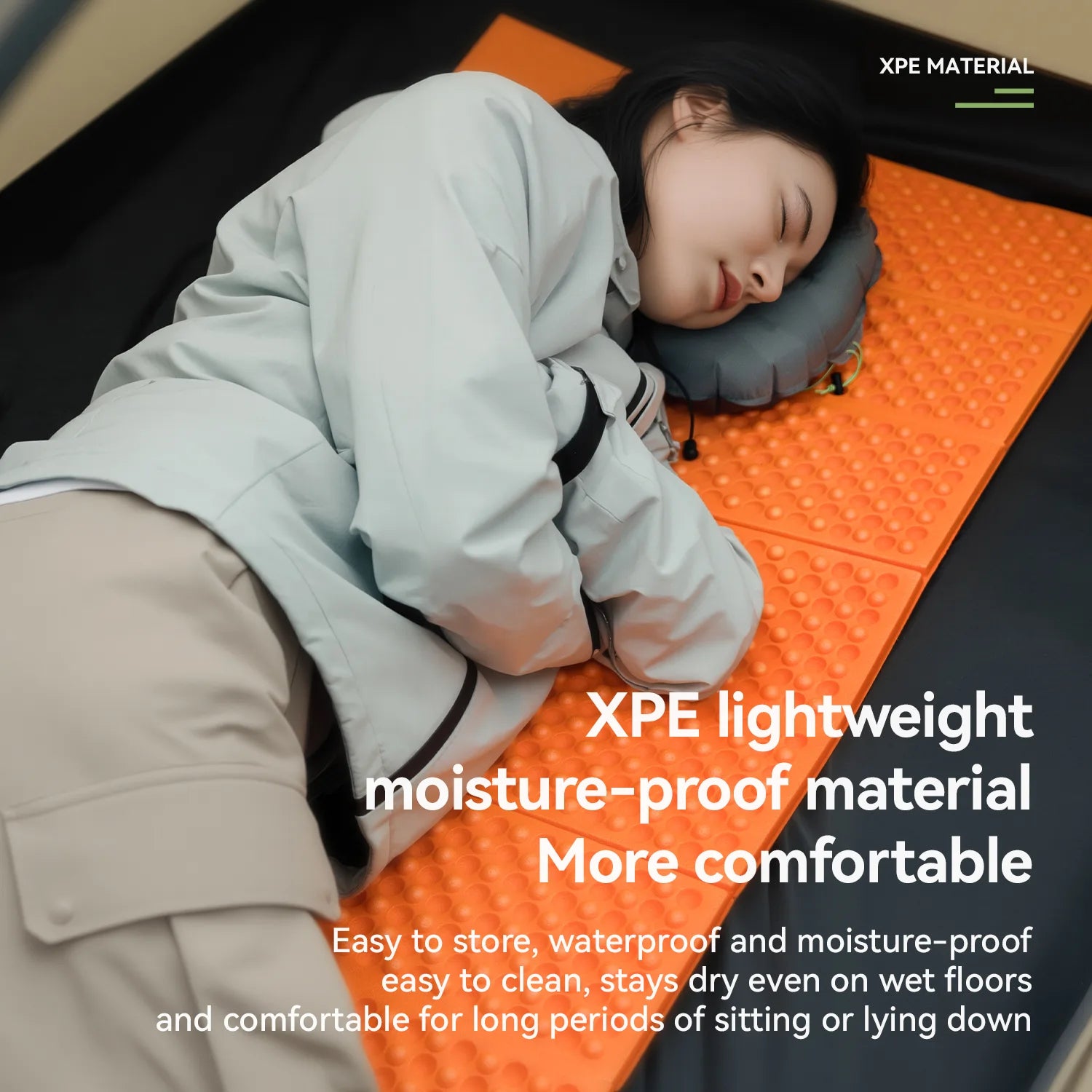 Person lying on an orange XPE material mat with text highlighting its features.