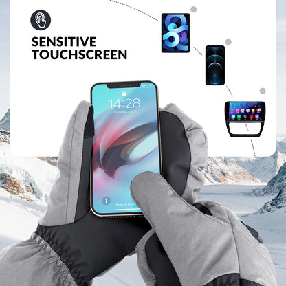 Person wearing gloves holding a smartphone with a snowy landscape background