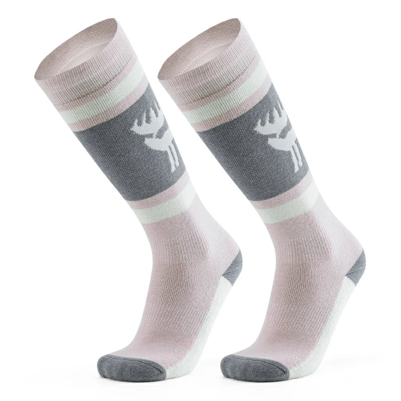 A pair of pink wool ski socks with a striped design and a reindeer logo on the ankle.