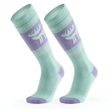 A pair of green wool ski socks with a striped design and a reindeer logo on the ankle.
